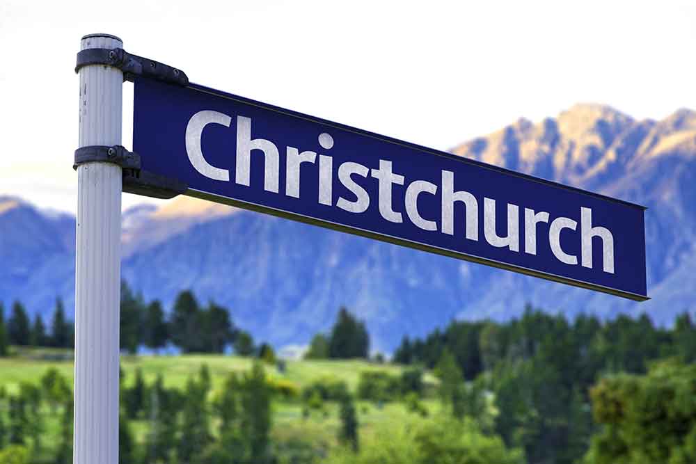 christchurch-road-sign-in-front-of-mountains