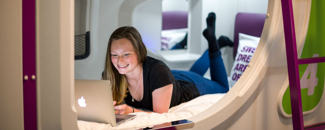 girl-on-laptop-inside-pod-in-jucy-snooze-christchurch